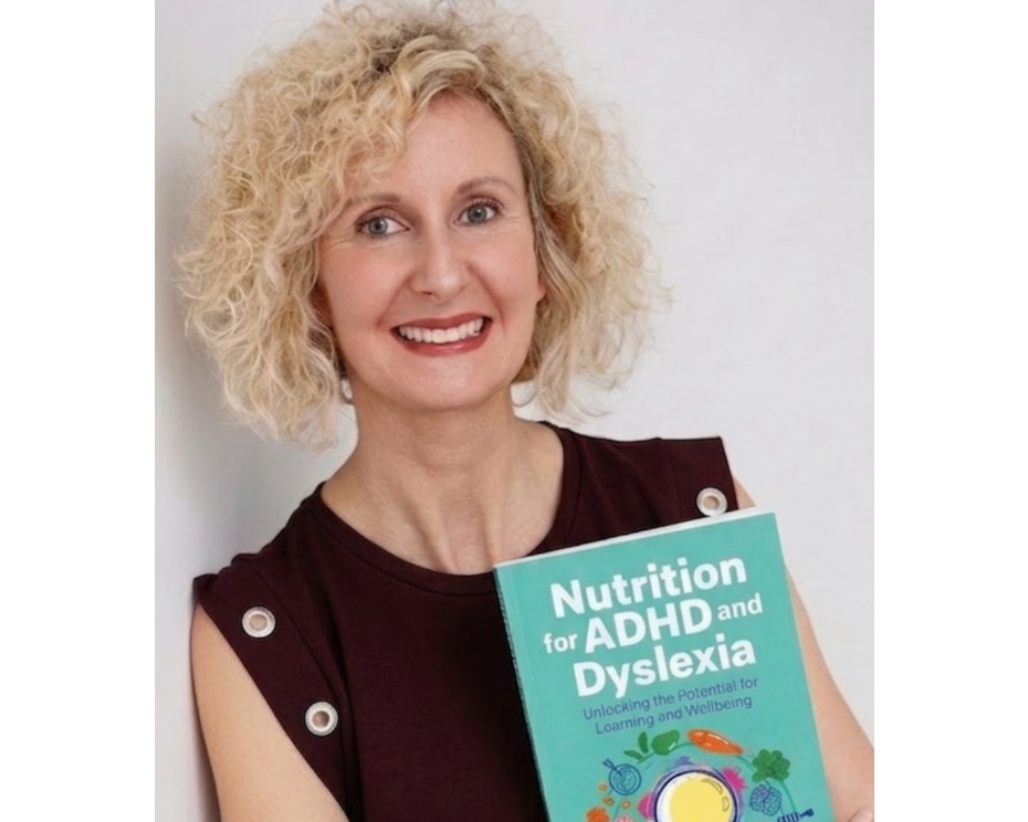 Woman holding a book titled 'Nutrition for ADHD and Dyslexia' against a plain background